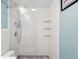 Modern bathroom showcases a pristine glass-enclosed shower, rain showerhead, and patterned tile floor at 1332 Ash St, Denver, CO 80220