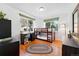 Bedroom with a bunk bed, desk, and a view of mature trees outside of the large window at 1332 Ash St, Denver, CO 80220