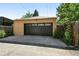 Detached garage featuring a modern door, clean lines, and ample parking space at 1332 Ash St, Denver, CO 80220