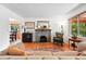 Cozy living room featuring hardwood floors, fireplace, and a comfortable sofa at 1332 Ash St, Denver, CO 80220
