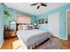 Comfortable main bedroom featuring blue walls, hardwood floors, and a large window at 1332 Ash St, Denver, CO 80220