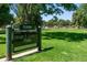 A sign for Henry S. Lindsley Park with lush green grass and trees in the background at 1332 Ash St, Denver, CO 80220