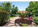 Beautiful patio space with stone pavers, surrounded by lush landscaping and mature trees at 1332 Ash St, Denver, CO 80220