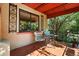 Charming patio area with decorative metal work, tile floor, and shade trees at 1332 Ash St, Denver, CO 80220