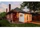 Exterior of home showing brick facade and white outbuilding with landscaping at 4430 Zuni St, Denver, CO 80211