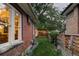 Backyard view showing brick house, covered patio and lawn at 4430 Zuni St, Denver, CO 80211