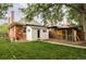 Landscaped backyard showing white outbuilding, brick facade, chicken coop and green lawn at 4430 Zuni St, Denver, CO 80211