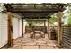 Covered patio with stone floor, dining table, benches and string lights at 4430 Zuni St, Denver, CO 80211