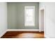 Empty bedroom with hardwood floors, white trim and a door that leads to a walk-in closet at 4430 Zuni St, Denver, CO 80211