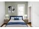 Bedroom with blue accents and a door that leads to a walk-in closet at 4430 Zuni St, Denver, CO 80211