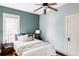 Inviting bedroom with a ceiling fan, plush pillows, and natural light from the window at 4430 Zuni St, Denver, CO 80211