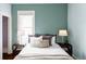 Cozy bedroom with a bed, neutral colored walls, and two bedside tables with lamps at 4430 Zuni St, Denver, CO 80211