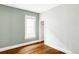 Empty bedroom with hardwood floors, white trim and a door that leads to a walk-in closet at 4430 Zuni St, Denver, CO 80211