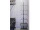 Walk-in closet with blue floral wallpaper, metal shelving and storage containers at 4430 Zuni St, Denver, CO 80211