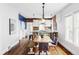 Charming dining area with exposed brick, pendant lighting, and a rustic wooden table at 4430 Zuni St, Denver, CO 80211