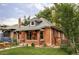 Charming brick home featuring a well-manicured lawn and inviting front entrance at 4430 Zuni St, Denver, CO 80211