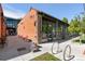 Brick building with large display windows and outdoor seating, offering a vibrant commercial space at 4430 Zuni St, Denver, CO 80211
