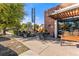 Restaurant exterior with outdoor seating under a pergola, surrounded by lush greenery and bike racks at 4430 Zuni St, Denver, CO 80211