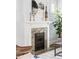 Close-up of the fireplace with white mantle and unique tiling at 4430 Zuni St, Denver, CO 80211