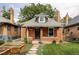 Charming brick home with a cozy front porch, landscaped yard, and inviting curb appeal at 4430 Zuni St, Denver, CO 80211