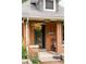 Close-up of the front porch with brick detail and hanging flower basket at 4430 Zuni St, Denver, CO 80211