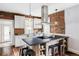 Modern kitchen features exposed brick, custom island and stainless steel appliances at 4430 Zuni St, Denver, CO 80211