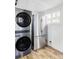 Laundry room with washer/dryer combo and a stainless steel refrigerator at 4430 Zuni St, Denver, CO 80211