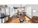 Open floor plan with hardwood floors, dining area, and exposed brick accents at 4430 Zuni St, Denver, CO 80211