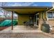 Back patio with dining set, grill, and storage tank at 482 W Caley Ave, Littleton, CO 80120