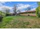 Large backyard featuring mature trees, green grass, and exterior of home at 482 W Caley Ave, Littleton, CO 80120
