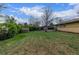 Large lawn with shade trees and the exterior of the home at 482 W Caley Ave, Littleton, CO 80120