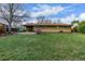 Spacious backyard with green lawn and mature trees at 482 W Caley Ave, Littleton, CO 80120