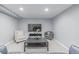 Basement living room includes a plush armchair and contemporary gray sofa at 482 W Caley Ave, Littleton, CO 80120