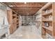 Unfinished basement with exposed duct work and wooden shelves at 482 W Caley Ave, Littleton, CO 80120