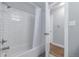 Bathroom with white subway tiled shower and view into an adjoining room at 482 W Caley Ave, Littleton, CO 80120