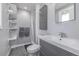 Modern bathroom featuring a sleek vanity, shower, and open shelving for storage at 482 W Caley Ave, Littleton, CO 80120