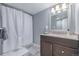 Bathroom with granite vanity, shower/tub combo, and well lit mirror at 482 W Caley Ave, Littleton, CO 80120