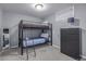 Bunk beds and dark dresser in a bedroom with gray walls and carpeting at 482 W Caley Ave, Littleton, CO 80120