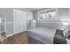 Cozy bedroom with hardwood floors, a window, closet, and neutral colored walls at 482 W Caley Ave, Littleton, CO 80120