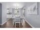 Bright dining room with hardwood floors, modern table and seating, and natural light at 482 W Caley Ave, Littleton, CO 80120