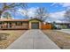 Charming home showcasing a front porch, a two-car garage, and ample parking at 482 W Caley Ave, Littleton, CO 80120