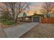 Charming single-story home with a spacious driveway and a cozy front porch, perfect for enjoying the sunset at 482 W Caley Ave, Littleton, CO 80120