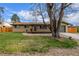 Well-maintained front yard with a lush lawn and a welcoming front porch, creating a picturesque curb appeal at 482 W Caley Ave, Littleton, CO 80120