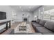 Bright living room with modern furniture, decorative fireplace, and large window bringing in natural light at 482 W Caley Ave, Littleton, CO 80120