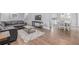 Inviting living room with hardwood floors, neutral paint, modern decor, and an open floor plan to the dining area at 482 W Caley Ave, Littleton, CO 80120