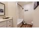 Well-lit bathroom with white cabinets, a vanity, and a shower-tub combination with clean lines and modern fixtures at 10239 W Fair Ave # A, Littleton, CO 80127