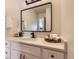 Clean and modern bathroom featuring a spacious vanity with stone countertops, a designer mirror and stylish fixtures and hardware at 10239 W Fair Ave # A, Littleton, CO 80127