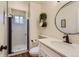 Modern bathroom with a glass-enclosed shower, marble countertops, and stylish decor at 10239 W Fair Ave # A, Littleton, CO 80127