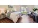 Inviting bedroom showcasing a comfortable bed, stylish furnishings, and ample natural light streaming through a large window at 10239 W Fair Ave # A, Littleton, CO 80127