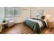 Relaxing bedroom showcasing soft, comfortable furnishings with large windows that filter in natural light at 10239 W Fair Ave # A, Littleton, CO 80127